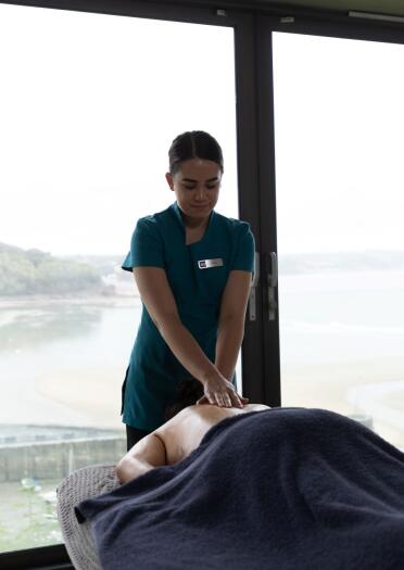 Masseuses working in a spa overlooking the coast.
