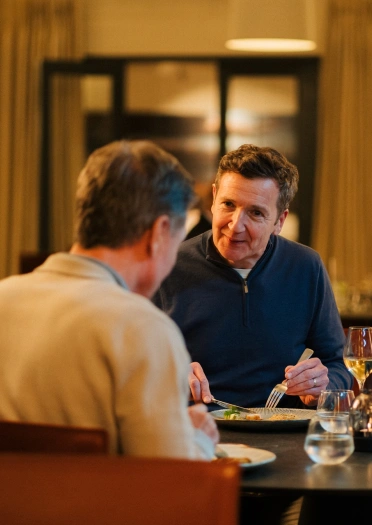 Two men having dinner at a Michelin starred restaurant.