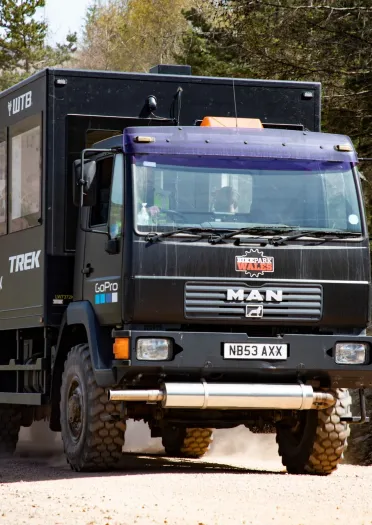 A truck taking bikers to the top of the cycling trail.