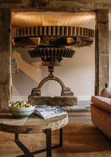 A mill house grinding stone in the middle of a living room