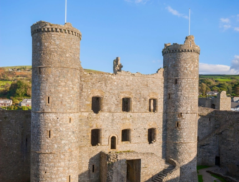 The courtyard of a well preserved castle seen from one of the high castle walls.