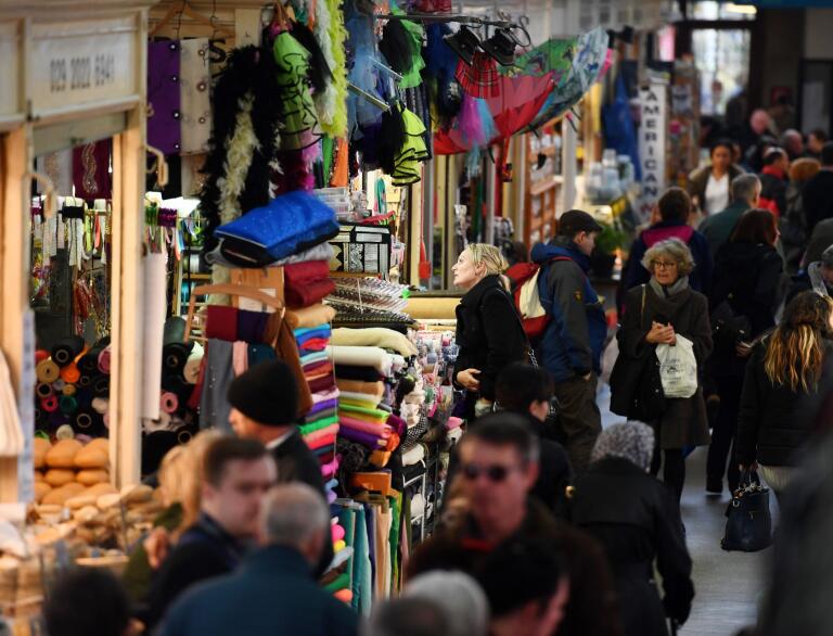 Shoppers browsing the stalls at Cardiff Indoor Market.