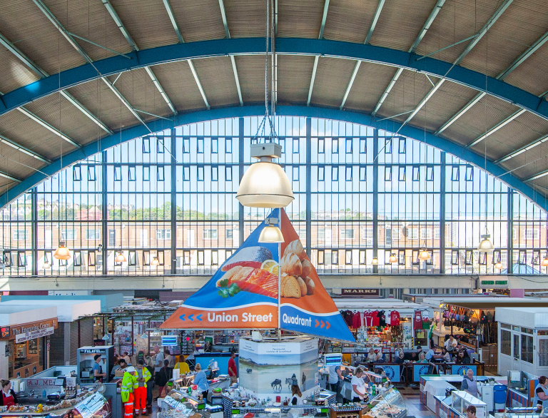 market stalls full of shoppers.