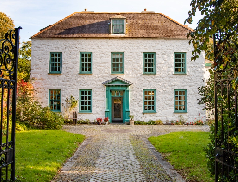 Exterior of Ty Newydd, a white painted house.