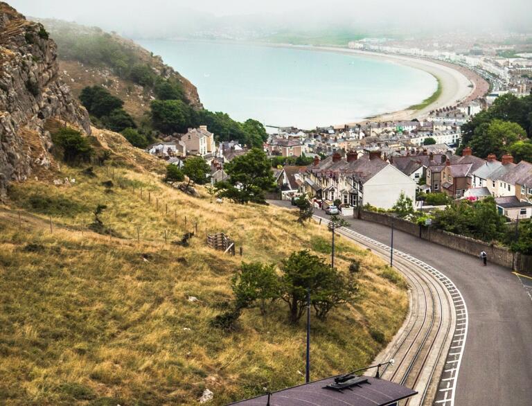 View of the Great Orme Tramway on a steep hill looking down to the sea.