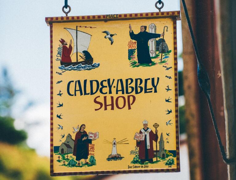 A sign handing from Caldey Abbey shop.