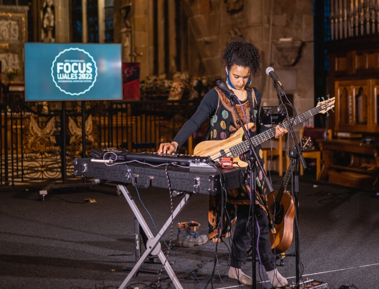 A musician playing multiple instruments in a church setting.
