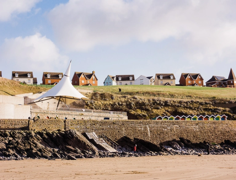 View from a beach toward the promenade of a seaside resort.