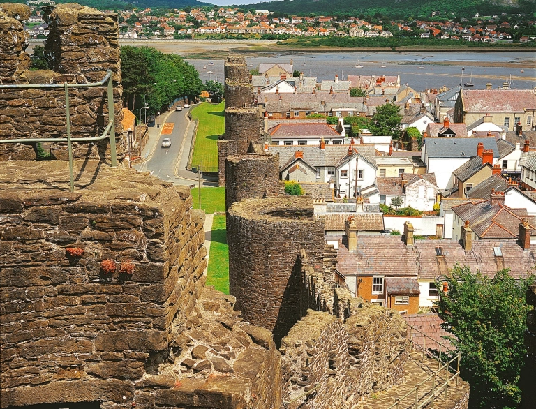 Medieval, walkable walls of a town with views of the harbour beyond.