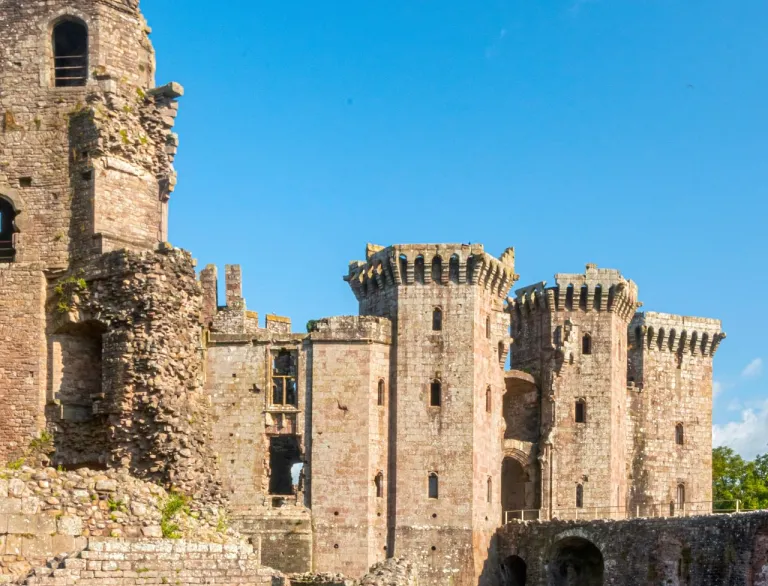 Towers of a castle surrounded by a moat.