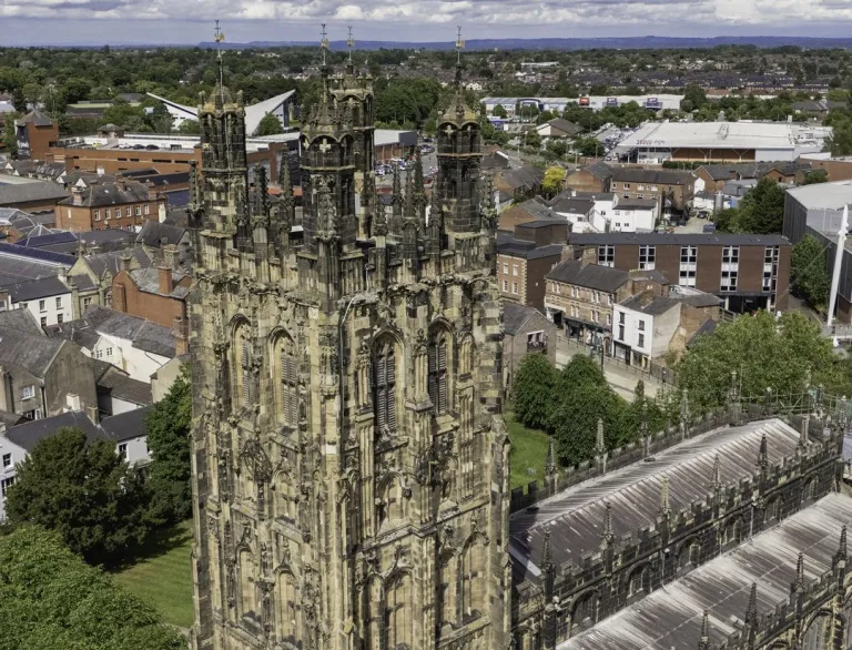 Aerial shot of a church, with a football stadium in the background.