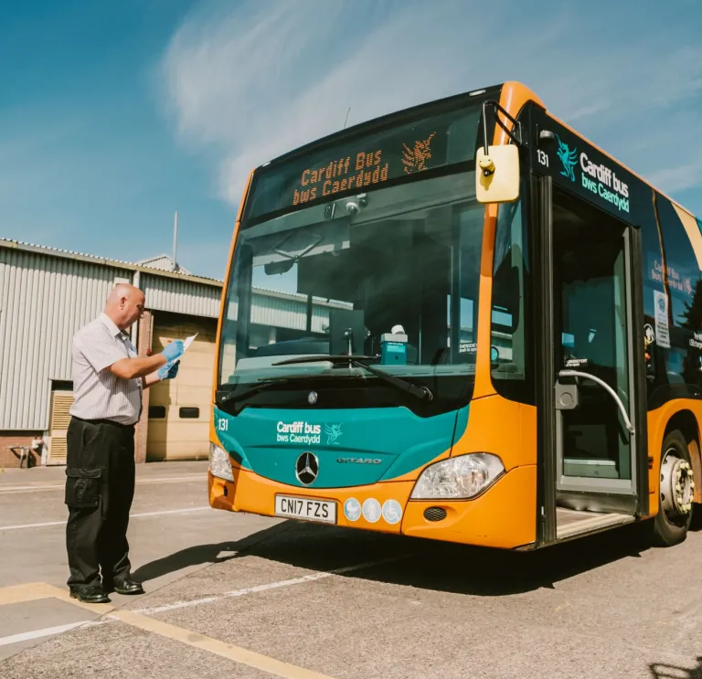 A driver inspecting his bus before heading to Cardiff Bay.