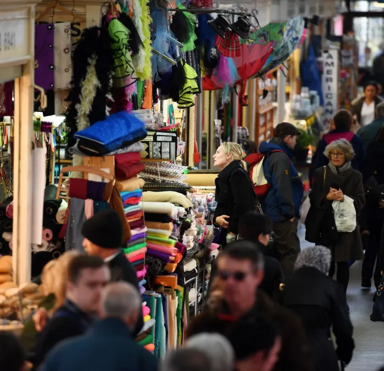 Shoppers browsing the stalls at Cardiff Indoor Market.