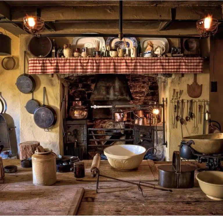 Kitchen dating back to 1870 with pots, pans and utensils hanging around the fire place.