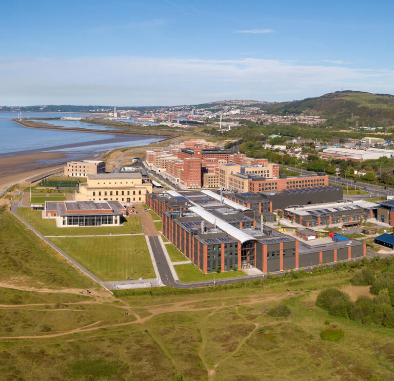 An aerial shot of Swansea University Bay Campus with views across the bay.