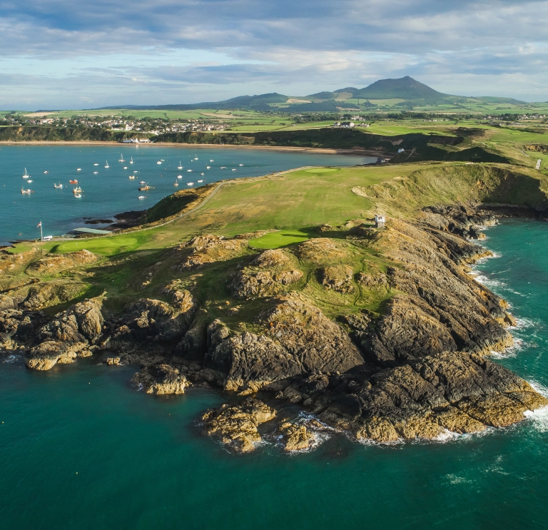 Nefyn golf course surrounded by the sea and mountains.