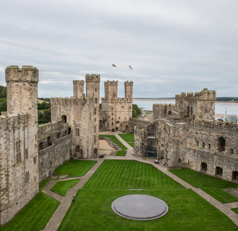 Inner courtyard of a castle with the estuary beyond.