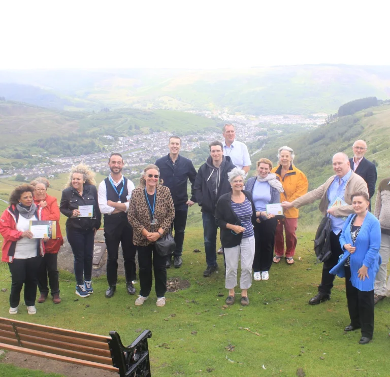 A group of people standing on a mountain on a tour of the valleys.