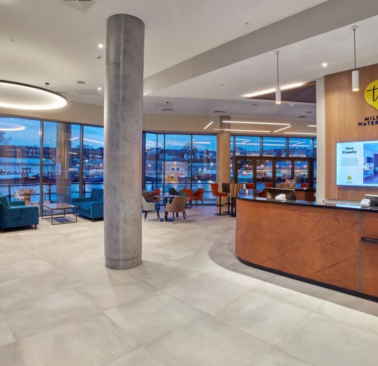 Reception area in a hotel with views of the harbour.