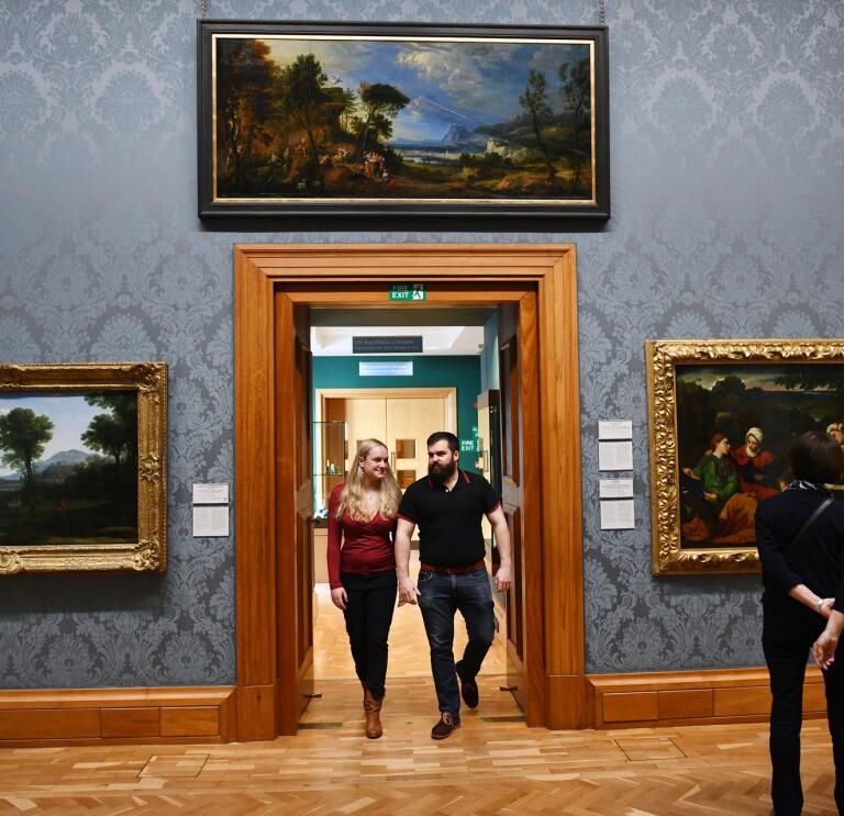 People viewing art on display at museum