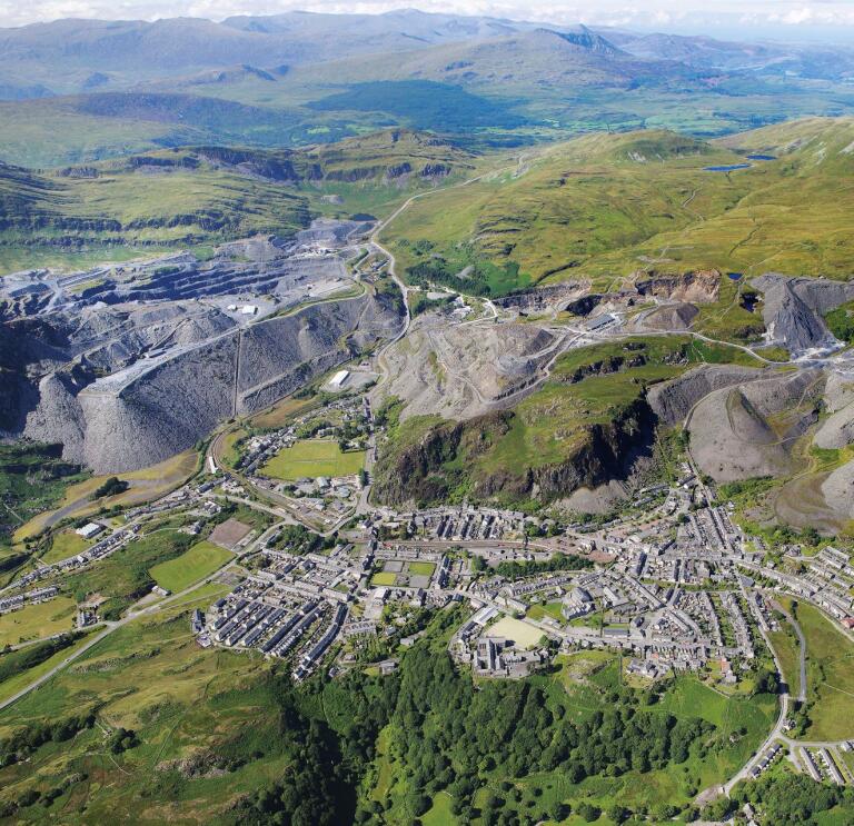 Aerial shot of a village and the slate quarries surrounding it.