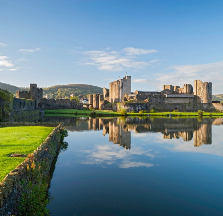 Castle overlooking a moat and greenery