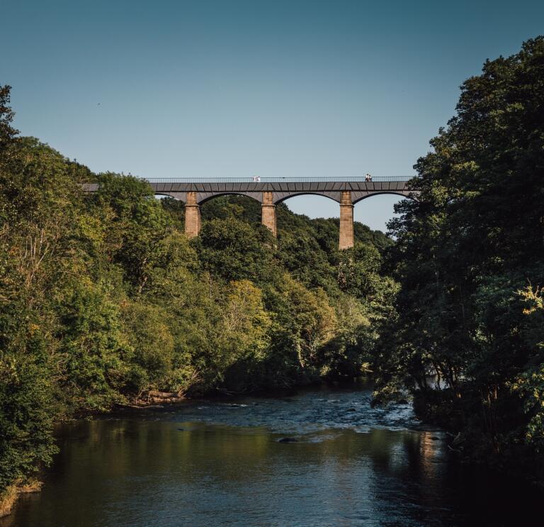 An aqueduct spanning high over a river.
