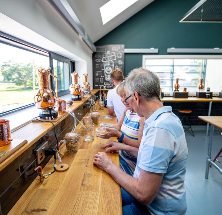 Visitors on a tasting tour at a distillery.
