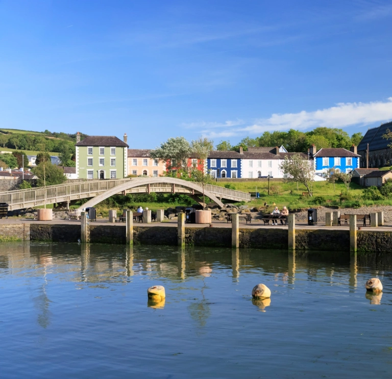 A footbridge going over the estuary in a pretty coastal town.