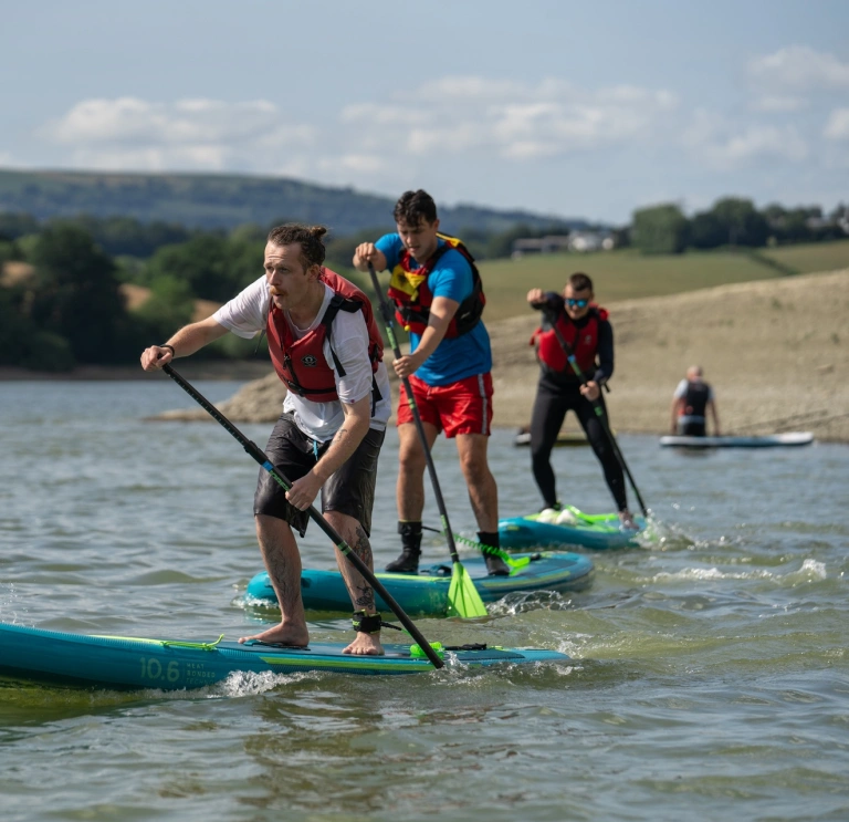Stand up paddleboarders on the water.