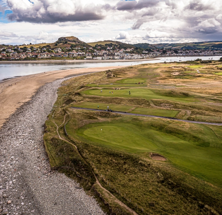 Aerial shot a a golf course by the sea.