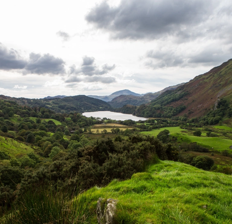 A lake surrounded by dramatic mountains and scenery.