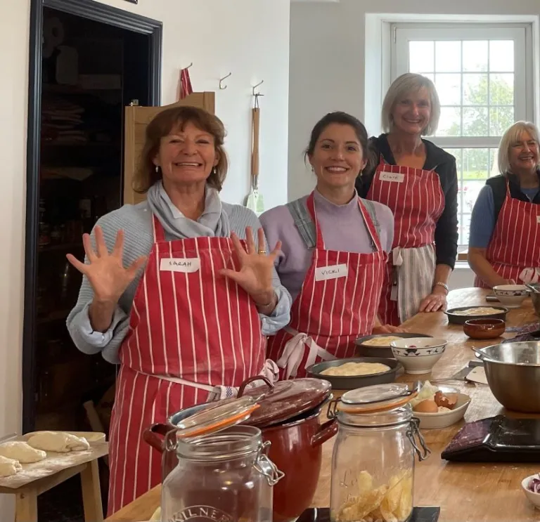 A group of people around a table at a baking class.