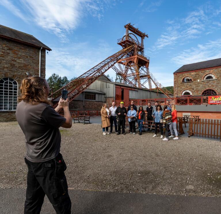 Group posing for a photo outside a coal mining experience.
