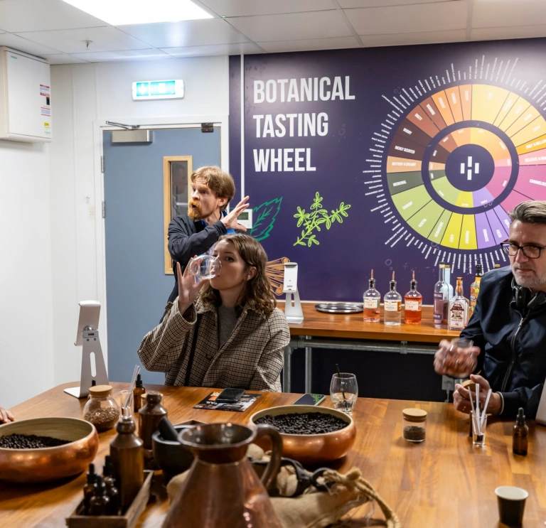 Group of people taste testing on a distillery tour.