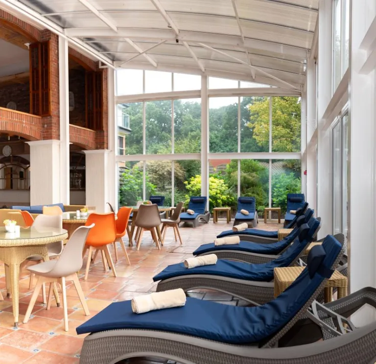 A conservatory and outdoor seating in a spa.