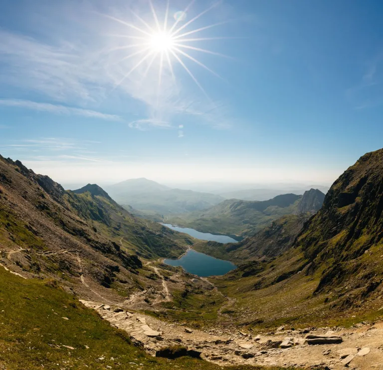 A mountain pass with views of lakes between them.