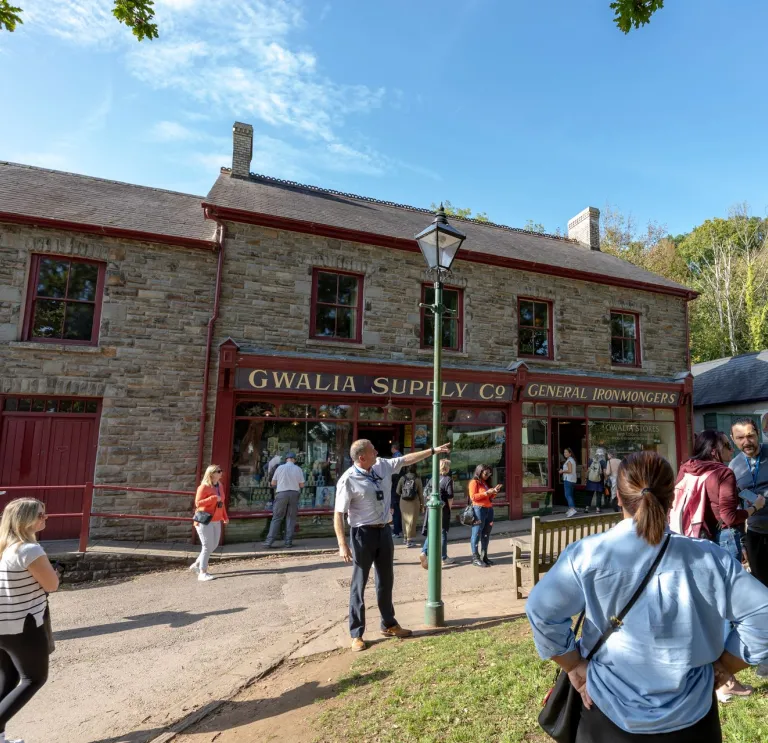 A guide taking a group of people around a history museum.