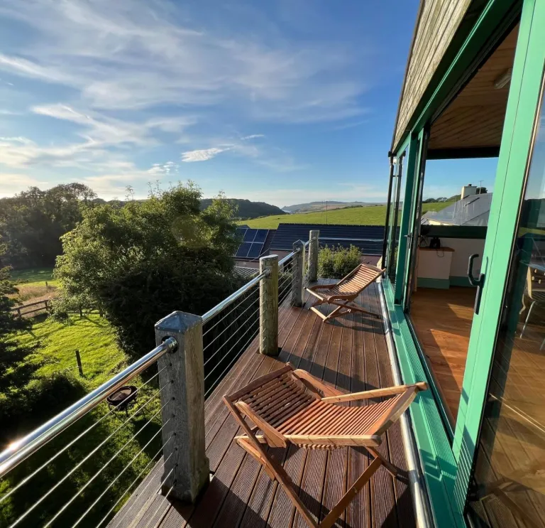 Seating on the balcony of an accommodation with countryside views.