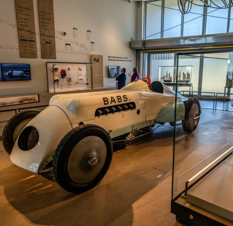 An old motor car on display in a land speed museum.