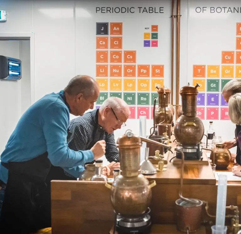 Group of people making gin at a workshop.