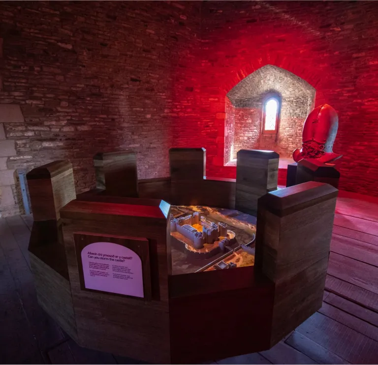 A round table showing a virtual castle in a castle tower.