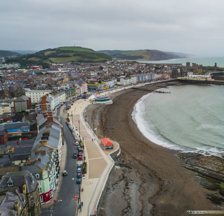 A coastline and town taken from the top of a cliff.