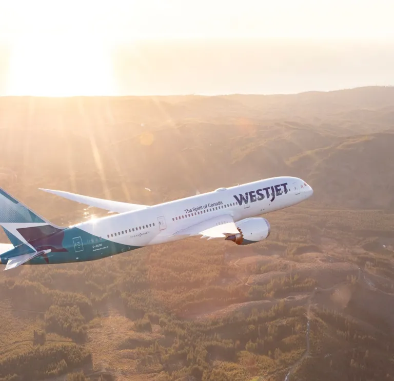 Aircraft flying high above a mountain range.