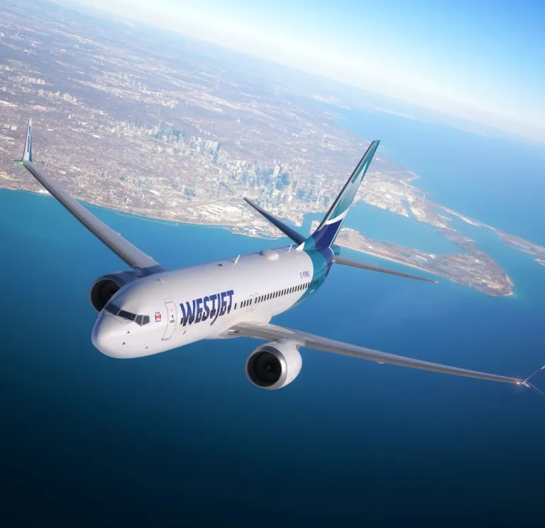 An aircraft in the sky above the sea.