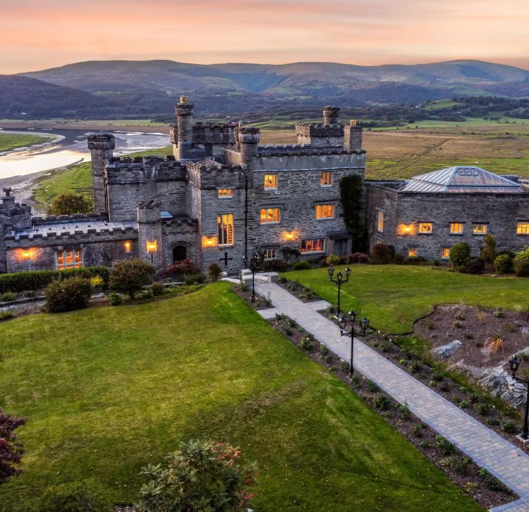 Aerial shot of a stately castle accommodation at twilight.