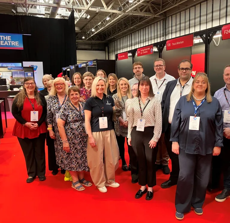 Group of people at a trade show smiling at the camera