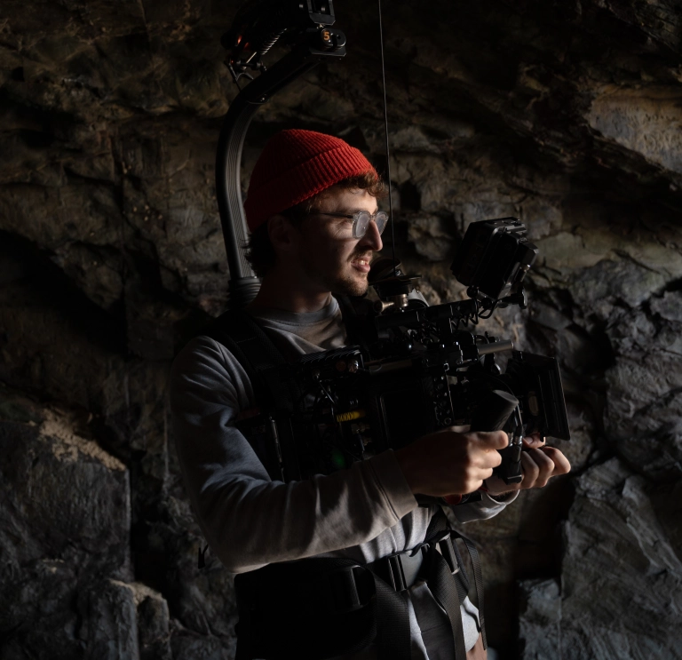 A man with a filming camera.
