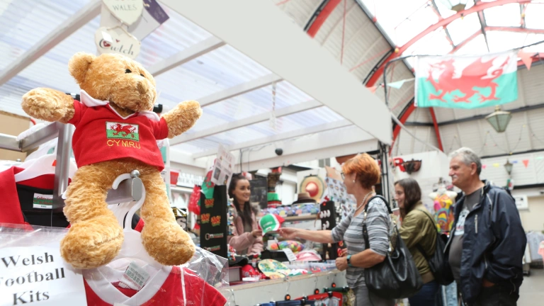 A stall in a market selling Welsh branded souvenirs.