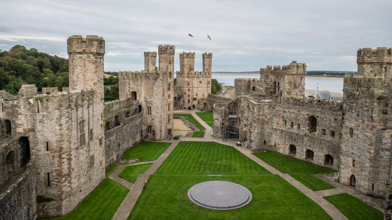 Inner courtyard of a castle with the estuary beyond.